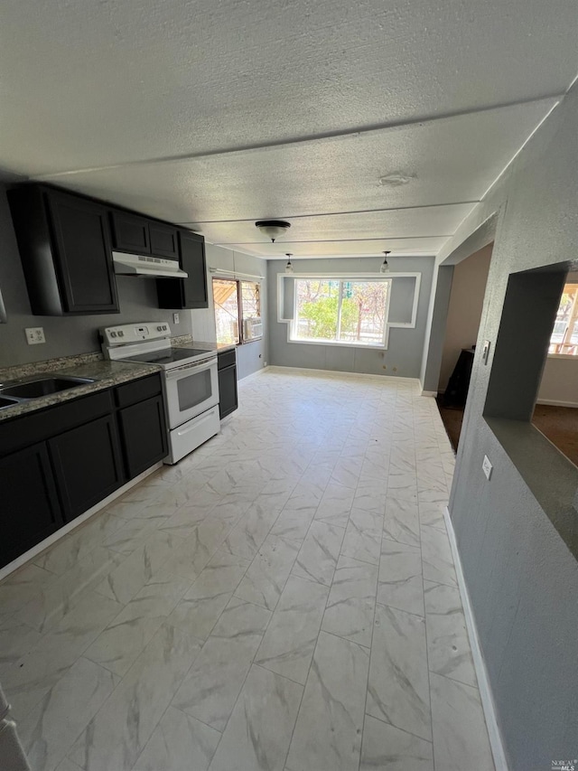 kitchen with white range with electric cooktop, sink, light tile floors, and a textured ceiling