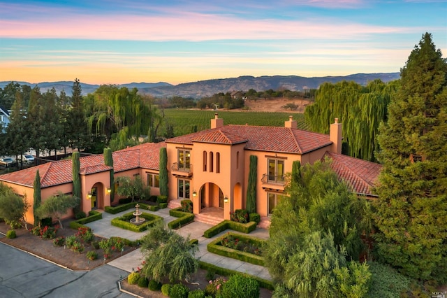 mediterranean / spanish house featuring a mountain view