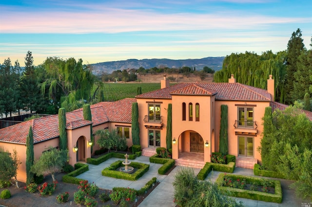 mediterranean / spanish-style house featuring a mountain view and french doors