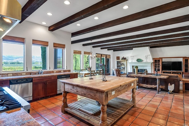 kitchen featuring light tile floors, dishwasher, and sink