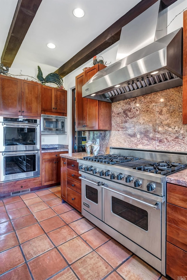 kitchen featuring appliances with stainless steel finishes, backsplash, wall chimney exhaust hood, and light stone countertops