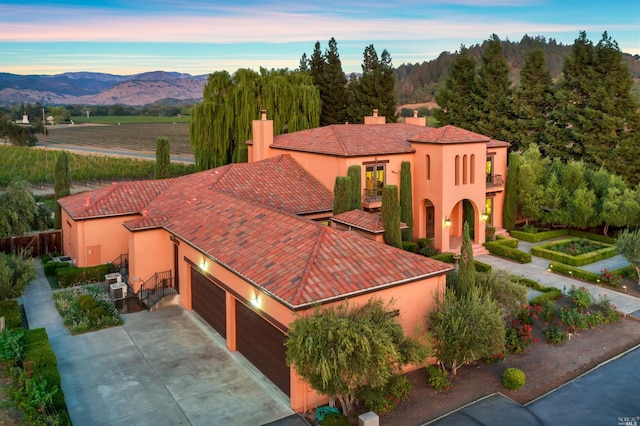 view of front of home featuring a mountain view and a garage