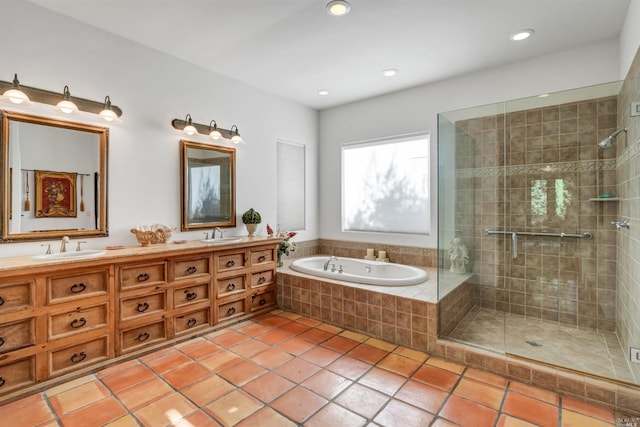 bathroom featuring oversized vanity, tile floors, independent shower and bath, and dual sinks