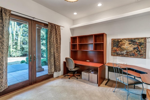 home office with french doors and light carpet