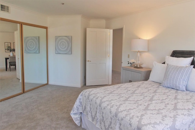 carpeted bedroom featuring crown molding and a closet