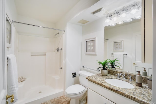 bathroom featuring vanity, tile flooring, toilet, and walk in shower