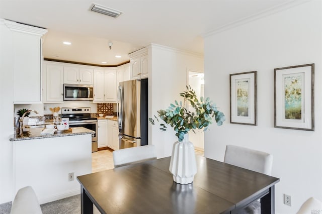 dining room with light carpet and sink