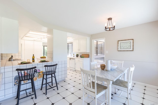 tiled dining area with a chandelier