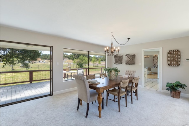 dining room with an inviting chandelier and light colored carpet