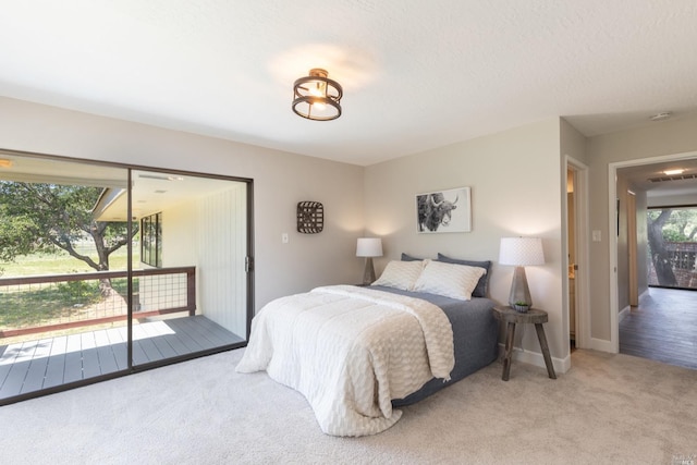 carpeted bedroom featuring access to outside