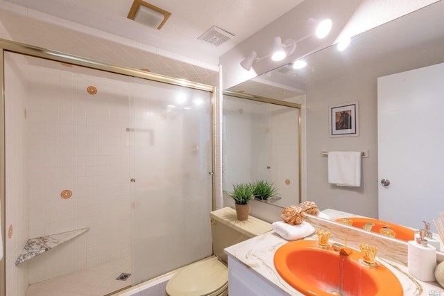 bathroom featuring walk in shower, large vanity, and toilet