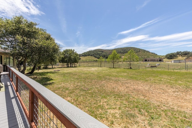 view of yard with a rural view and a mountain view