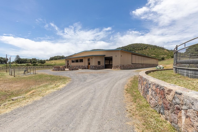 view of front of house with a rural view