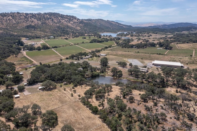 birds eye view of property with a water and mountain view and a rural view