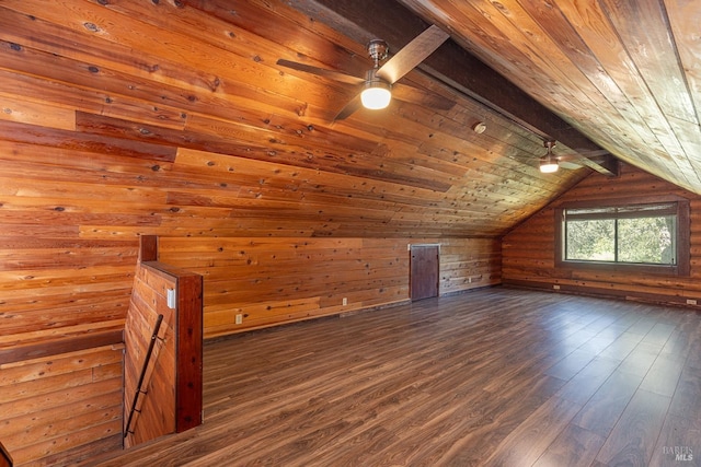 additional living space featuring vaulted ceiling with beams, wood walls, wood ceiling, and dark wood finished floors