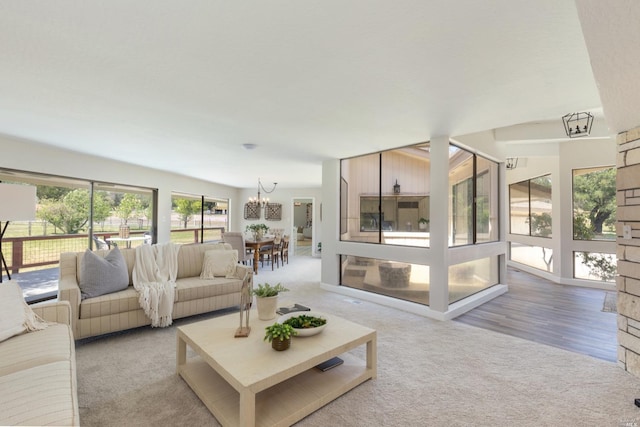 living room with an inviting chandelier and light colored carpet