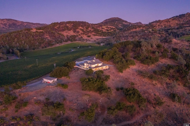 aerial view at dusk featuring a mountain view