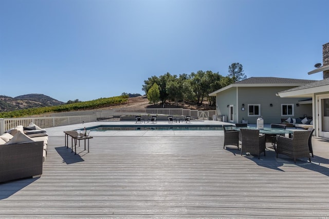 wooden deck with a fenced in pool