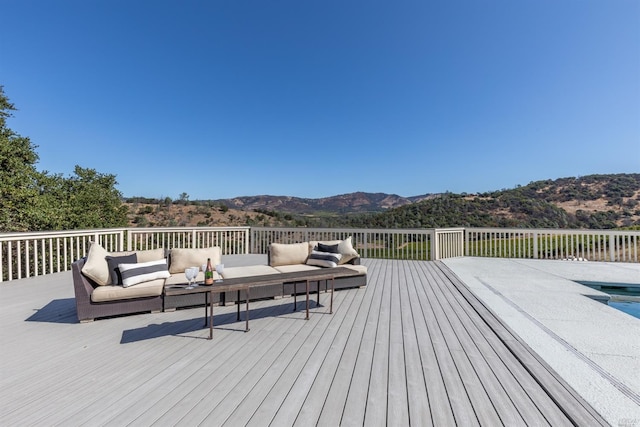 deck with a mountain view and an outdoor hangout area