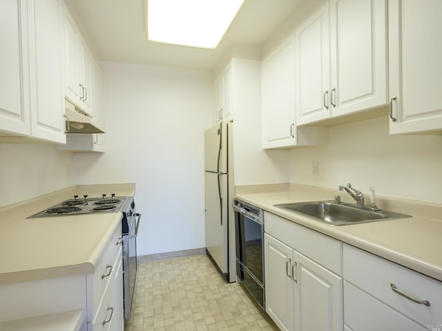 kitchen with white cabinets, custom exhaust hood, white appliances, sink, and light tile flooring