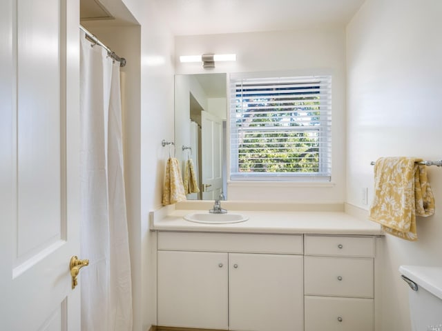 bathroom featuring vanity and toilet