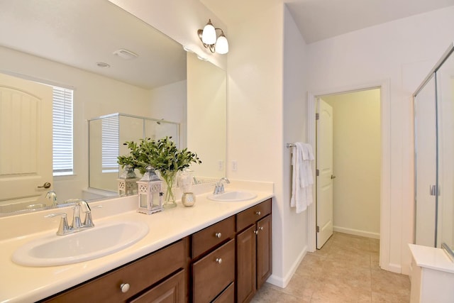 bathroom with a shower with door, tile floors, and double sink vanity