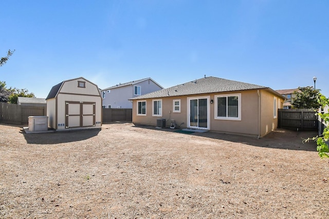 back of property featuring central AC unit, a patio area, and a shed