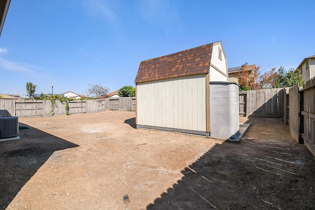 view of yard with central air condition unit and a storage unit