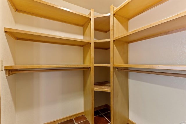 walk in closet featuring tile floors