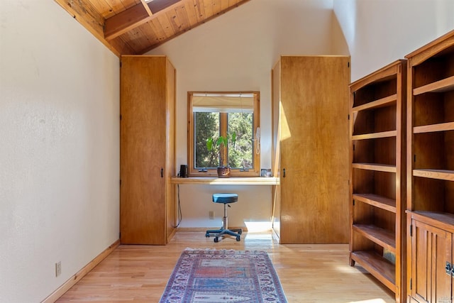 unfurnished office with wood ceiling, light hardwood / wood-style floors, built in desk, and lofted ceiling with beams