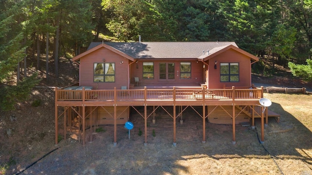 rear view of house featuring a deck