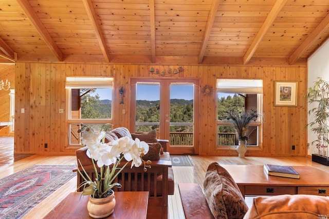 living room featuring wooden walls, light hardwood / wood-style floors, and wooden ceiling