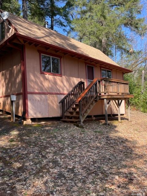 rear view of property featuring a deck