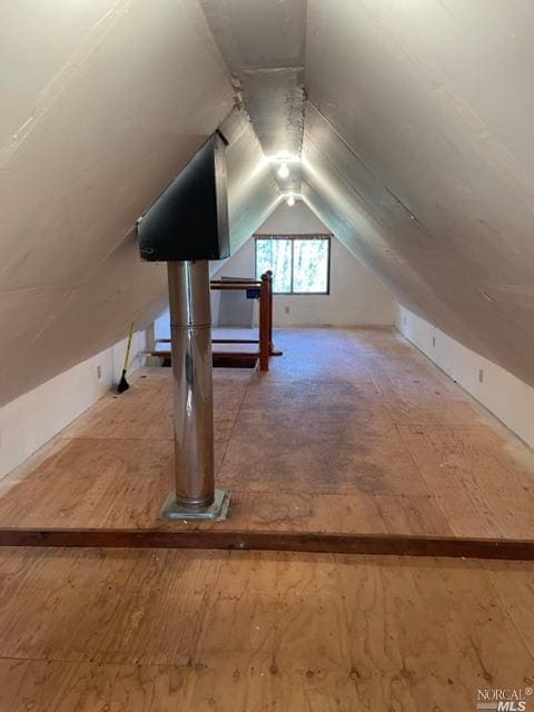 additional living space featuring lofted ceiling