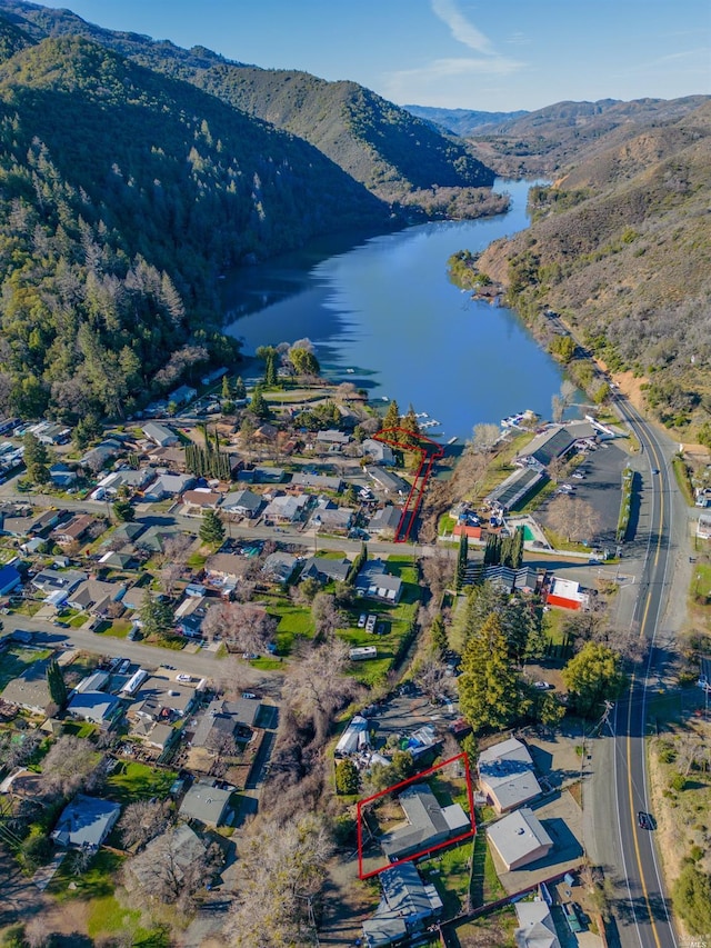 drone / aerial view featuring a water and mountain view