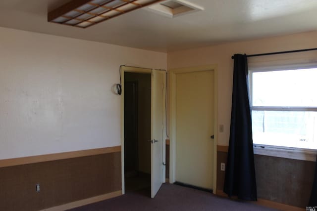 unfurnished bedroom featuring dark colored carpet