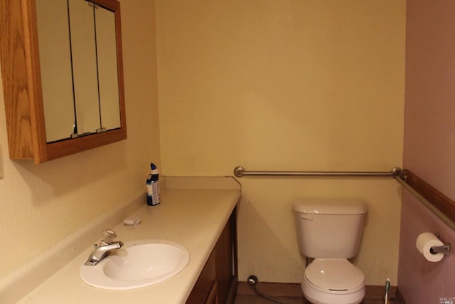 bathroom with toilet and vanity