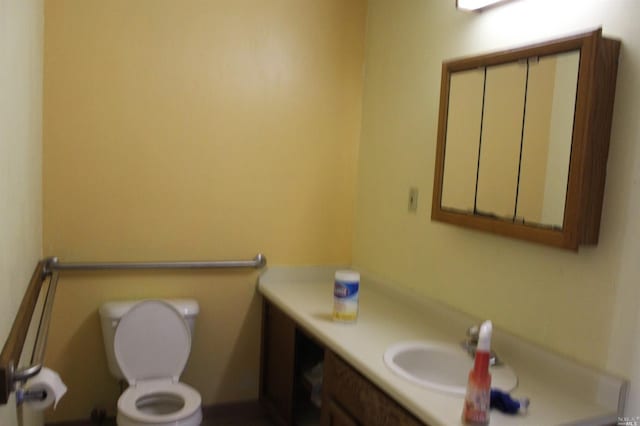 bathroom with toilet and vanity