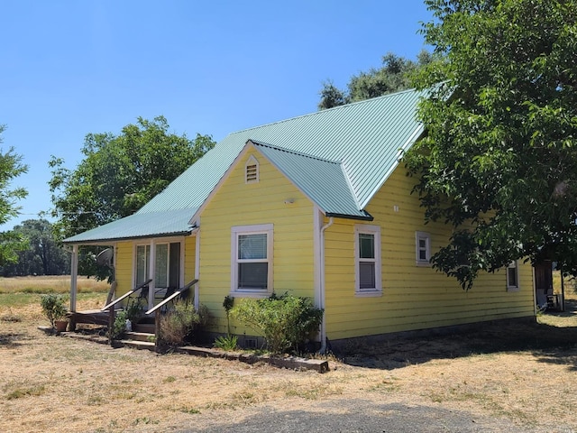 view of front facade with a porch and central AC unit