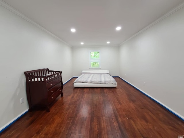 bedroom with crown molding and dark wood-type flooring