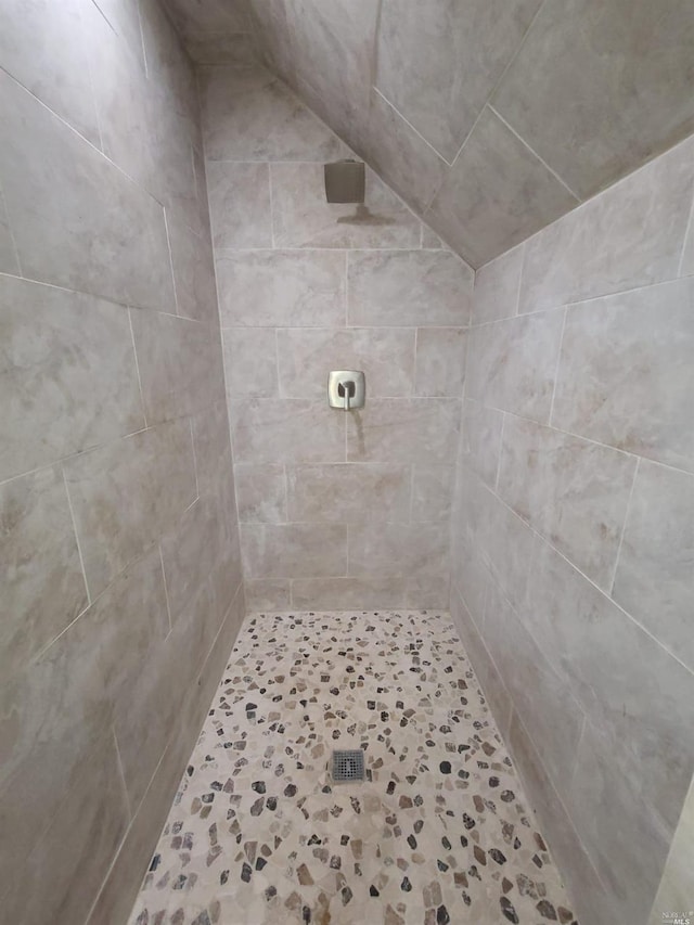 bathroom with a tile shower