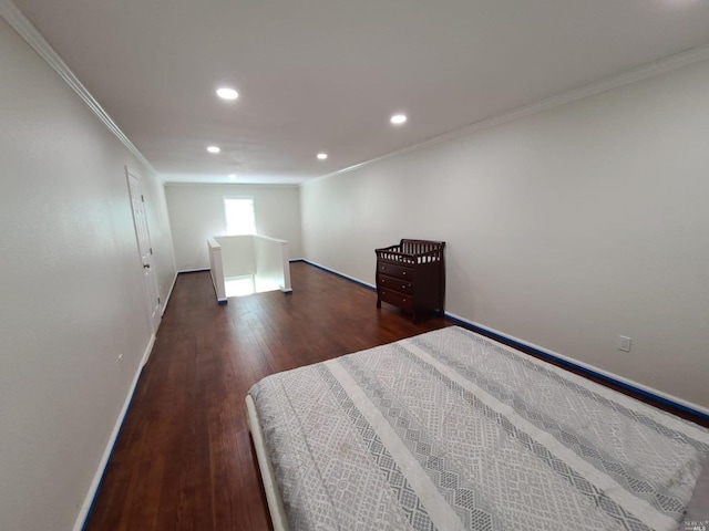 unfurnished bedroom featuring crown molding and dark hardwood / wood-style flooring