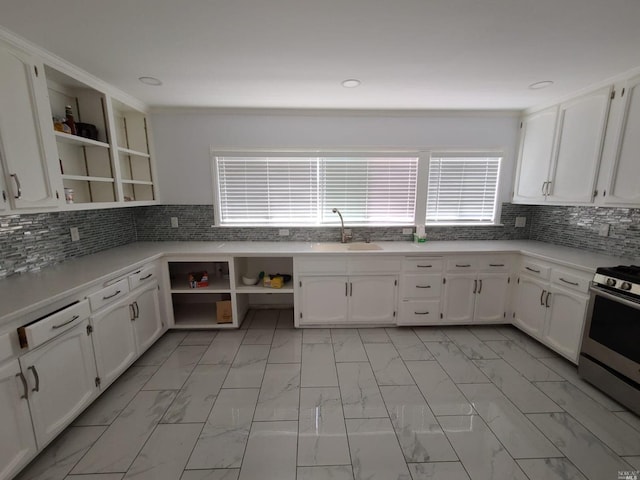 kitchen with tasteful backsplash and white cabinetry