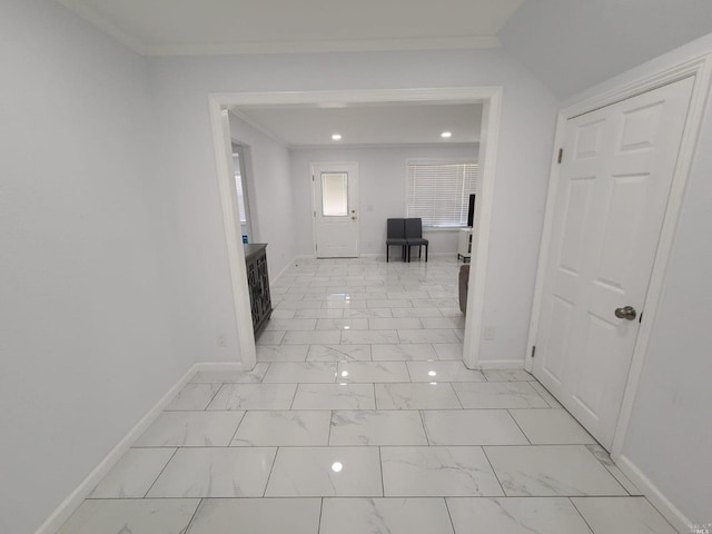 hallway with crown molding and light tile floors