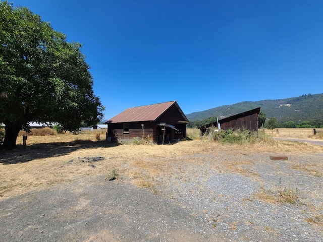 exterior space featuring a rural view and a mountain view