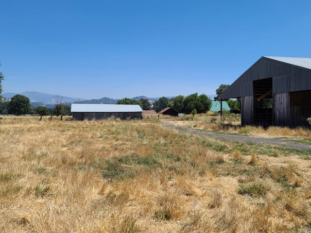 view of yard featuring a mountain view and a rural view