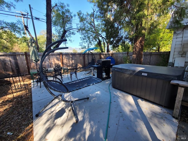 view of patio / terrace featuring area for grilling and a hot tub