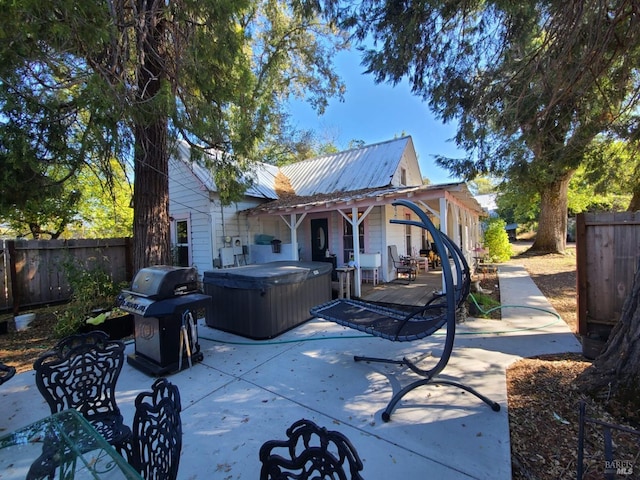 exterior space with a hot tub and a patio area