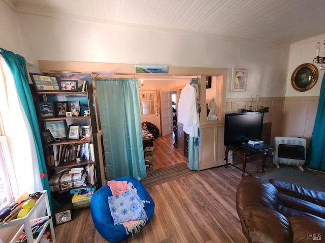 living room with heating unit and hardwood / wood-style floors