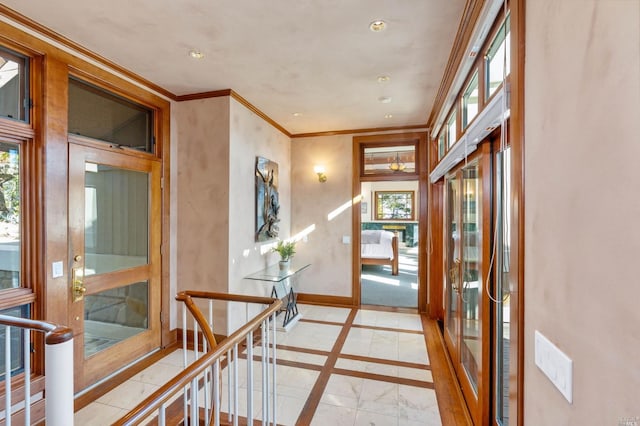 foyer featuring light tile floors, crown molding, and a healthy amount of sunlight